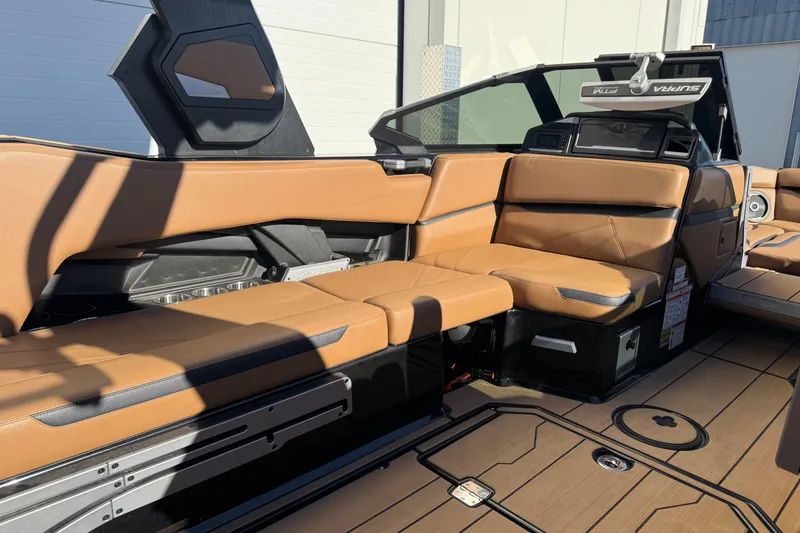 Slide: The Image of 2024 Supra SL 575 boat interior with tan leather seating and modern design. - 9