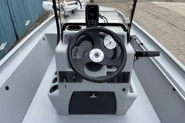 Slide: The Image of 2026 Tracker Bass Tracker Classic CC boat console with steering wheel and controls. - 12