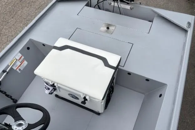 Slide: The Image of 2026 Tracker Bass Tracker Classic CC boat interior with steering wheel and cushioned seat. - 13