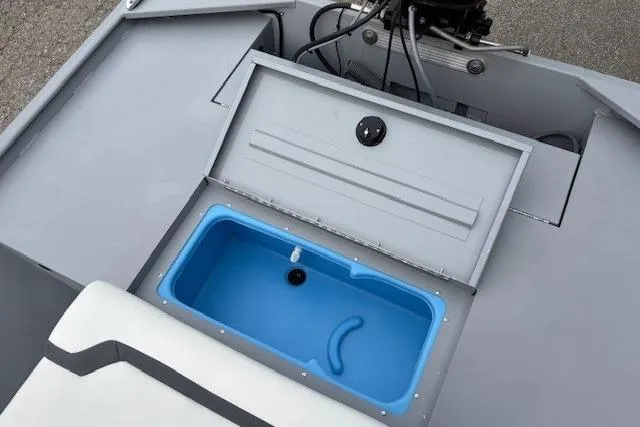 Slide: The Image of 2026 Tracker Bass Tracker Classic CC boat with open storage compartment and blue interior. - 16