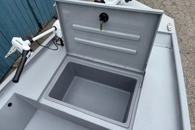 Slide: The Image of 2026 Tracker Bass Tracker Classic CC boat storage compartment with open lid and trolling motor. - 7