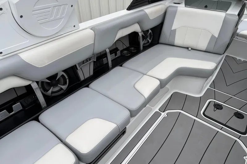 Slide: The Image of 2020 Malibu Wakesetter 25 LSV interior with gray and white seating, featuring built-in speakers. - 11