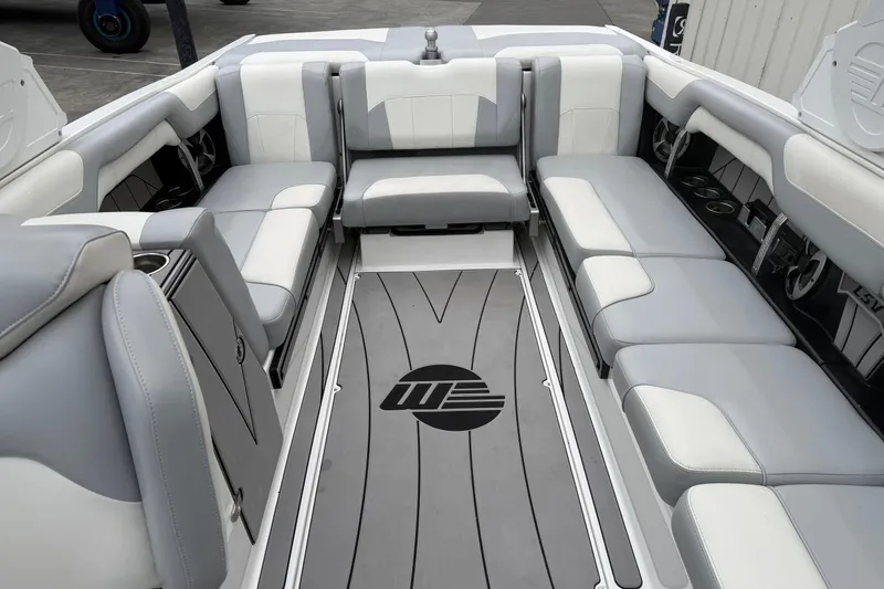 Slide: The Image of 2020 Malibu Wakesetter 25 LSV interior with gray and white seating, spacious layout. - 14