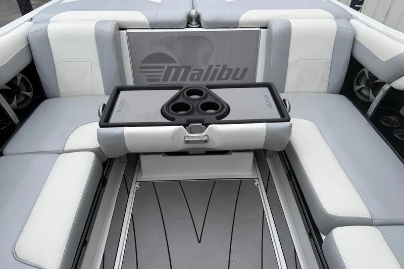 Slide: The Image of 2020 Malibu Wakesetter 25 LSV interior with gray and white seating and cup holders. - 16