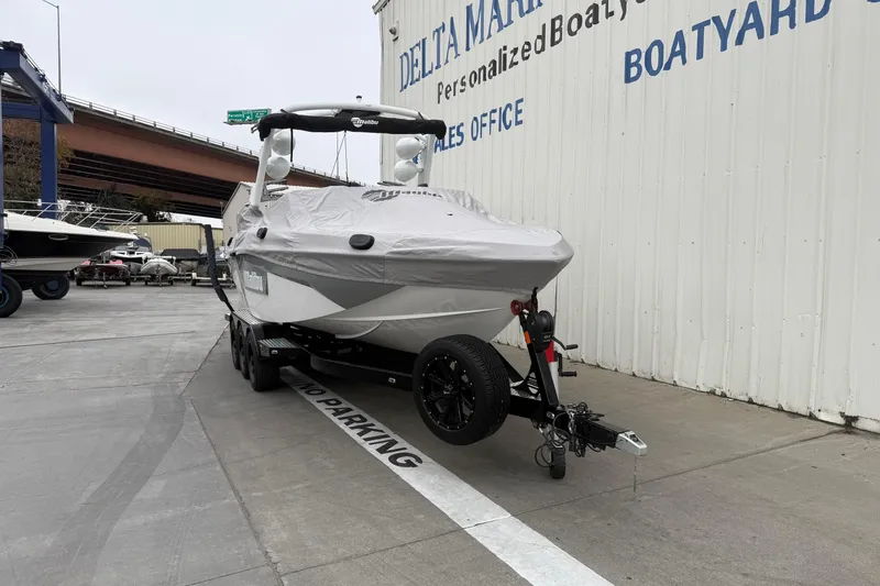 Slide: The Image of 2020 Malibu Wakesetter 25 LSV boat covered, parked at Delta Marine. - 25