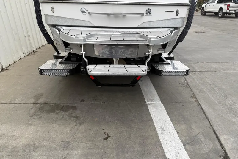 Slide: The Image of 2020 Malibu Wakesetter 25 LSV boat rear view on concrete surface. - 7