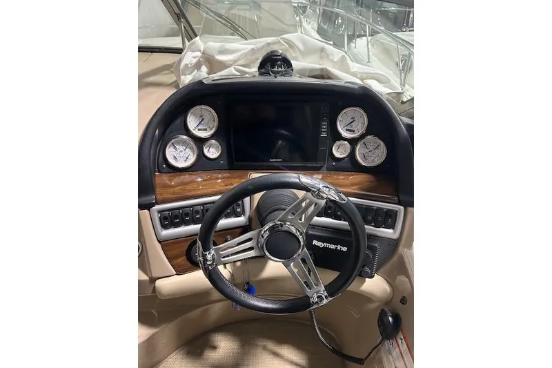 Slide: The Image of 2008 Four Winns 338 Vista boat dashboard with steering wheel and gauges. - 11