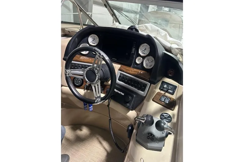 Slide: The Image of 2008 Four Winns 338 Vista boat dashboard with steering wheel and control panel. - 12