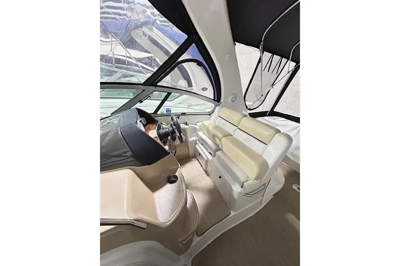 Slide: The Image of Interior of 2008 Four Winns 338 Vista boat with beige seating and steering wheel. - 13