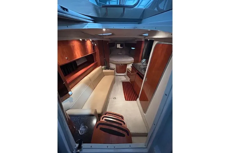 Slide: The Image of 2008 Four Winns 338 Vista cabin interior with seating, kitchenette, and cozy sleeping area. - 15