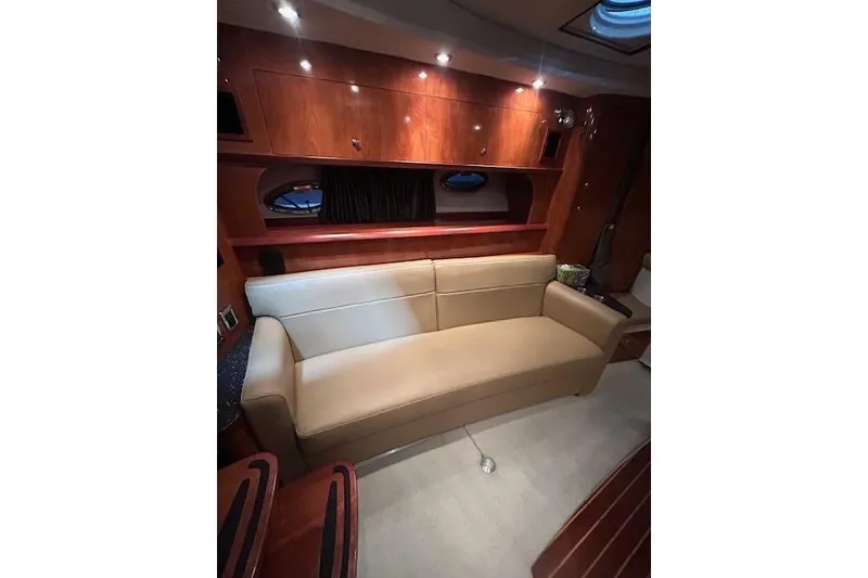 Slide: The Image of Interior of 2008 Four Winns 338 Vista yacht with beige sofa and wooden cabinetry. - 16