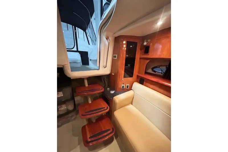Slide: The Image of Luxurious interior of 2008 Four Winns 338 Vista yacht with wooden steps and seating. - 18