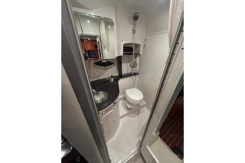 Slide: The Image of Compact bathroom in 2008 Four Winns 338 Vista boat, featuring shower, toilet, and sink. - 19