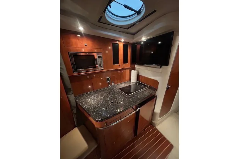 Slide: The Image of Luxurious 2008 Four Winns 338 Vista yacht interior with modern kitchen amenities. - 22
