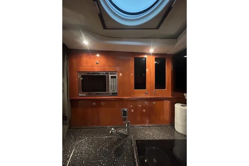 Slide: The Image of 2008 Four Winns 338 Vista yacht interior with wood cabinetry and modern kitchen amenities. - 24
