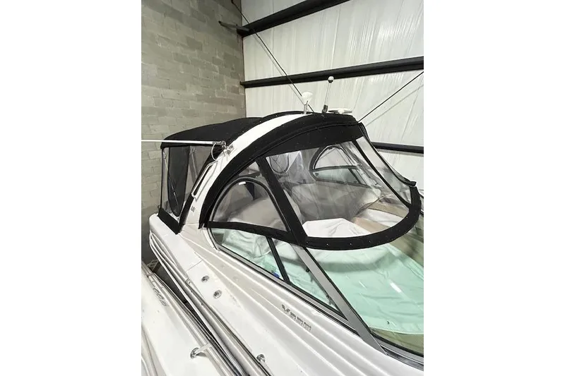Slide: The Image of 2008 Four Winns 338 Vista boat with black canopy in storage. - 3
