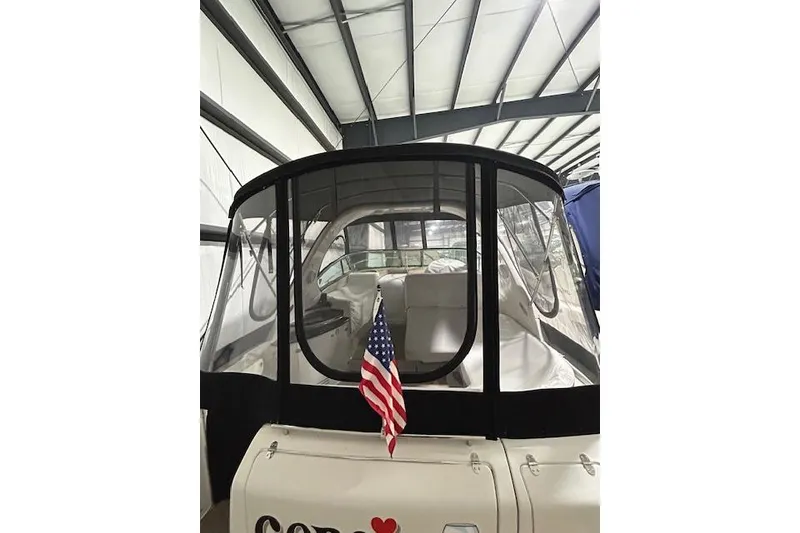Slide: The Image of 2008 Four Winns 338 Vista boat with American flag in a storage facility. - 5
