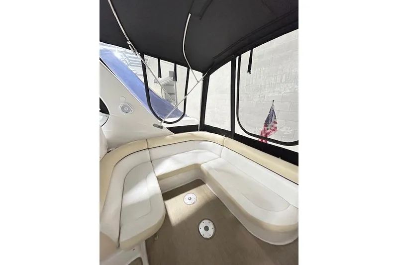 Slide: The Image of 2008 Four Winns 338 Vista boat interior with beige seating and American flag. - 8