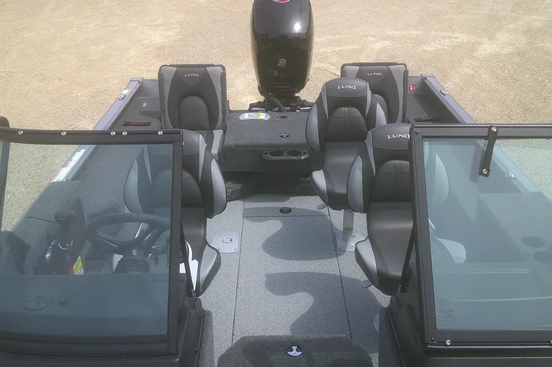 Slide: The Image of 2026 Lund 1875 Impact XS Sport boat interior with seating and steering wheel. - 10