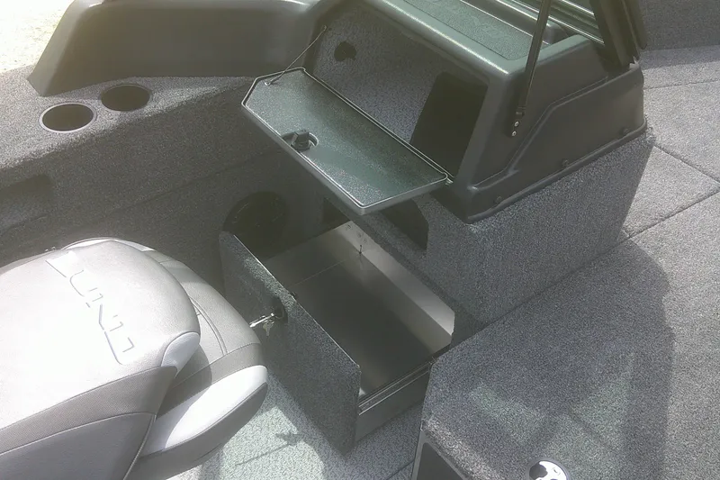 Slide: The Image of 2026 Lund 1875 Impact XS Sport boat interior with storage compartments and seating. - 13