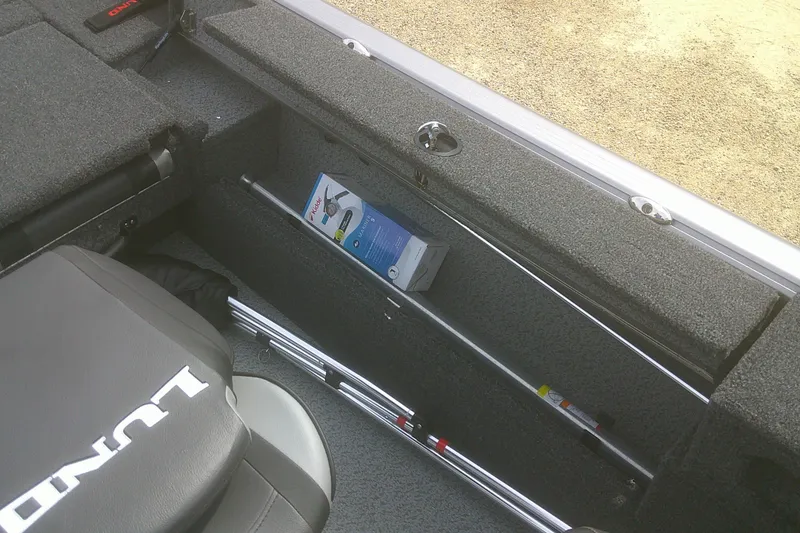 Slide: The Image of Interior of 2026 Lund 1875 Impact XS Sport boat showing storage compartment and seating. - 15