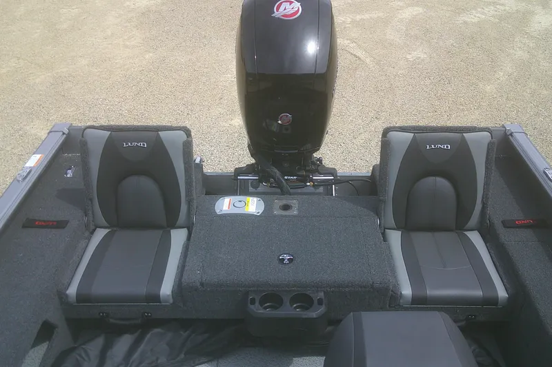 Slide: The Image of 2026 Lund 1875 Impact XS Sport boat interior with seating and motor. - 16