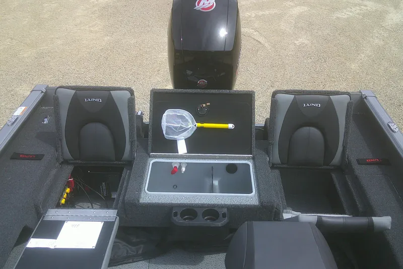 Slide: The Image of 2026 Lund 1875 Impact XS Sport boat interior with storage compartments and seating. - 17