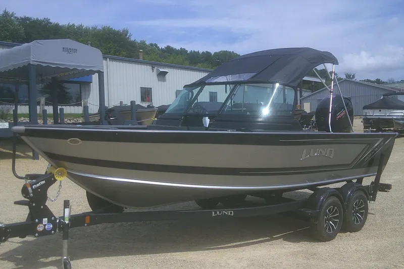 Slide: The Image of 2026 Lund 1875 Impact XS Sport boat on trailer, parked outdoors. - 3