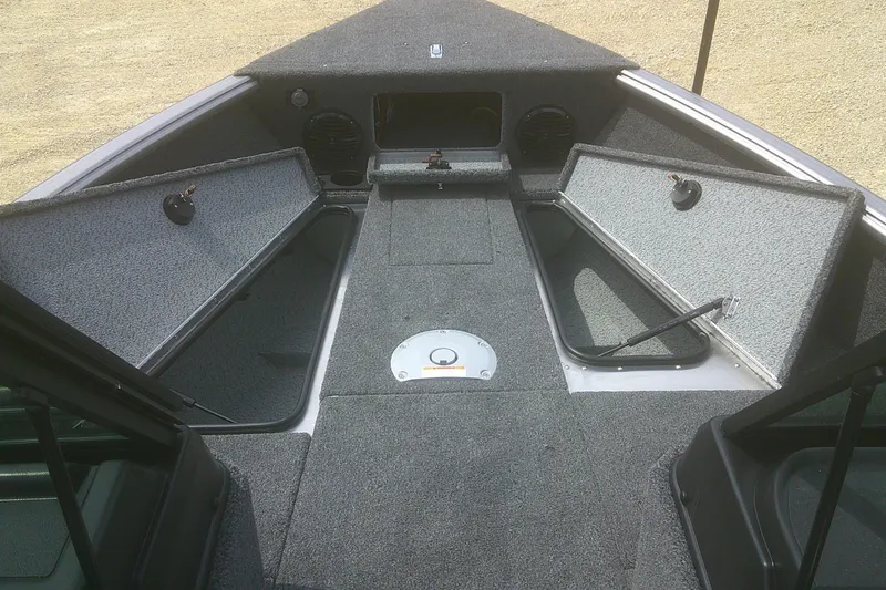 Slide: The Image of 2026 Lund 1875 Impact XS Sport boat interior with open storage compartments. - 7