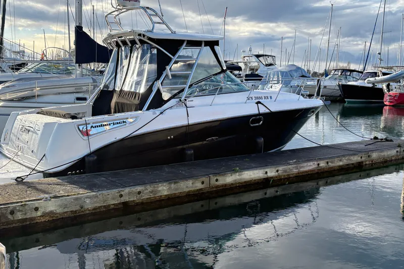 Slide: The Image of 2009 Sea Ray 290 Amberjack boat docked at marina, surrounded by other vessels. - 11