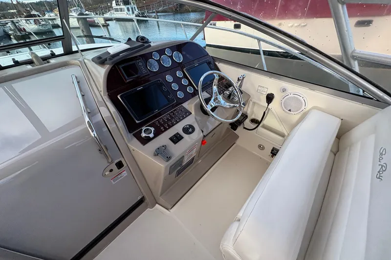 Slide: The Image of 2009 Sea Ray 290 Amberjack helm with steering wheel and control panel. - 47