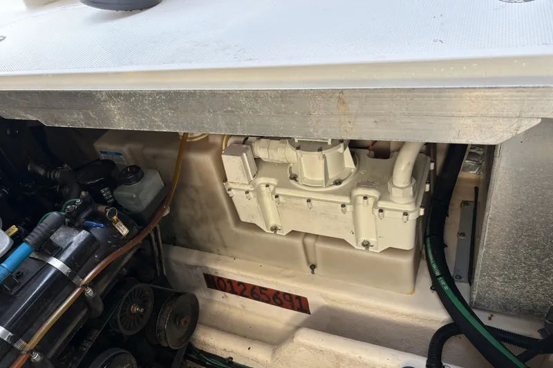 Slide: The Image of Engine compartment of a 2009 Sea Ray 290 Amberjack boat, showcasing mechanical components. - 54