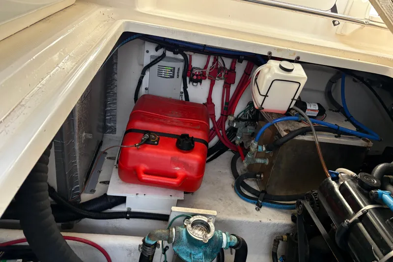 Slide: The Image of Engine compartment of a 2009 Sea Ray 290 Amberjack with red fuel tank and wiring. - 56