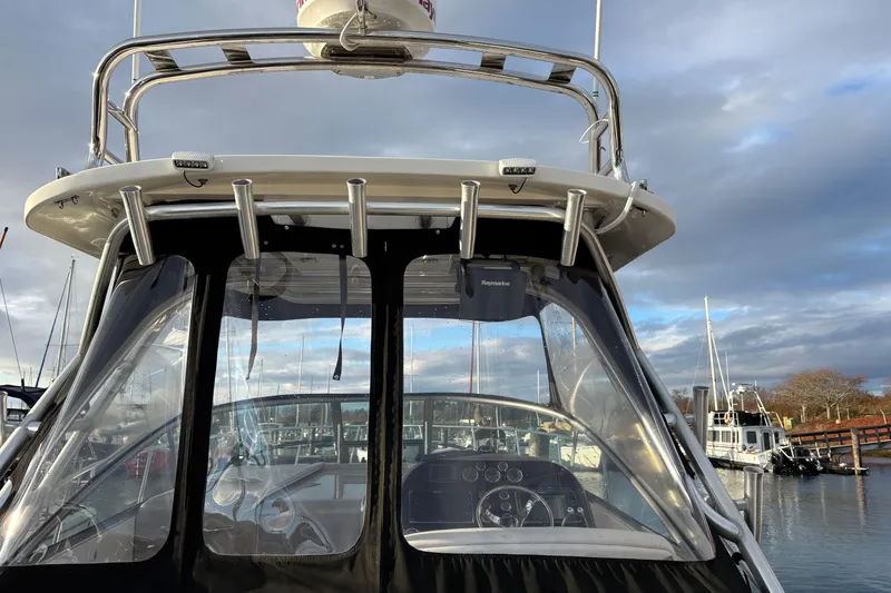 Slide: The Image of 2009 Sea Ray 290 Amberjack boat cockpit with clear enclosure, docked at marina. - 59