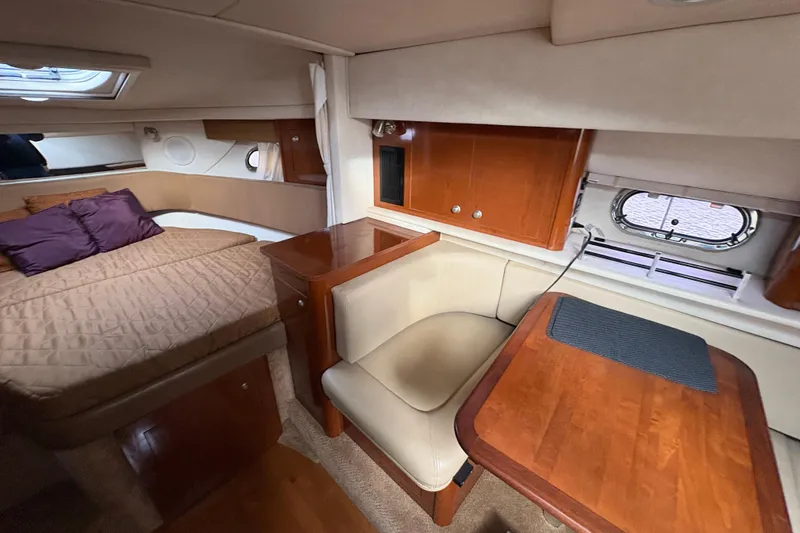 Slide: The Image of Interior of 2009 Sea Ray 290 Amberjack with cozy seating and wooden table. - 80