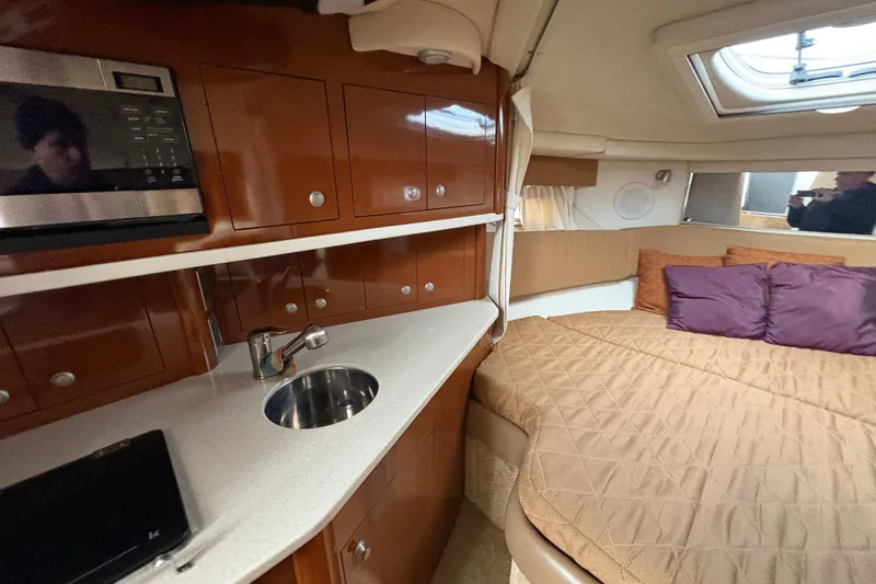 Slide: The Image of Interior of 2009 Sea Ray 290 Amberjack with kitchenette and cozy sleeping area. - 90