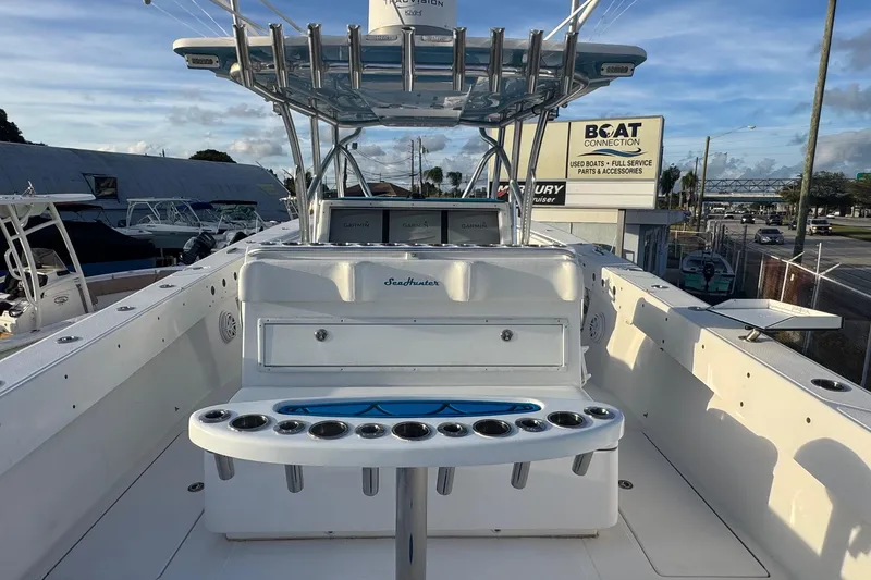 Slide: The Image of 2015 SeaHunter 41 Tournament boat with rod holders and Garmin electronics, docked at a marina. - 12