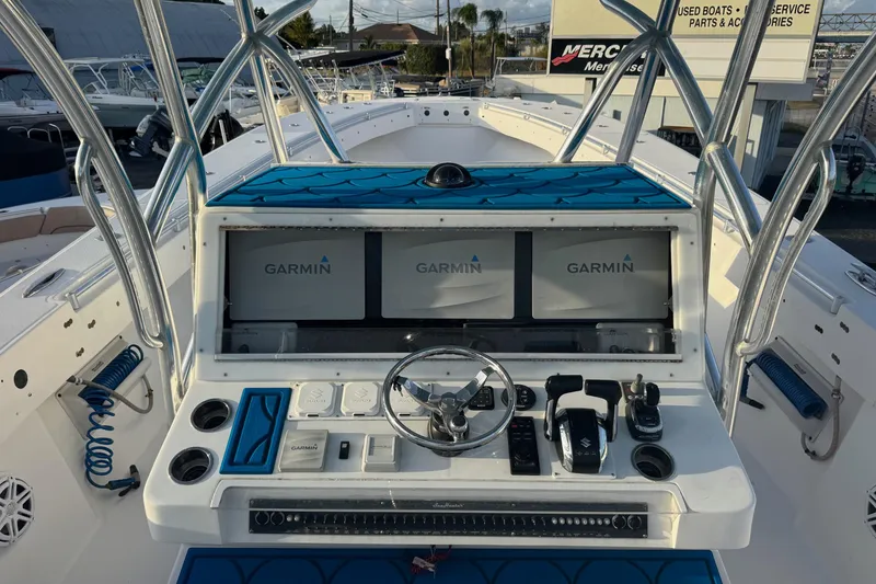 Slide: The Image of 2015 SeaHunter 41 Tournament boat dashboard with Garmin navigation displays and controls. - 13