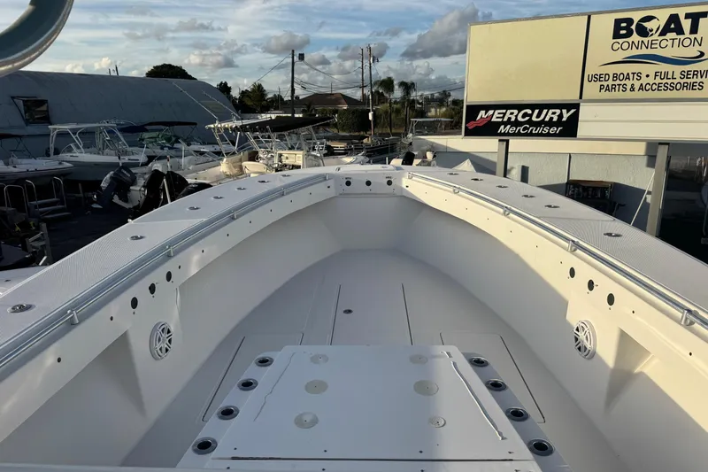 Slide: The Image of 2015 SeaHunter 41 Tournament boat at dealership, showcasing spacious deck and sleek design. - 14