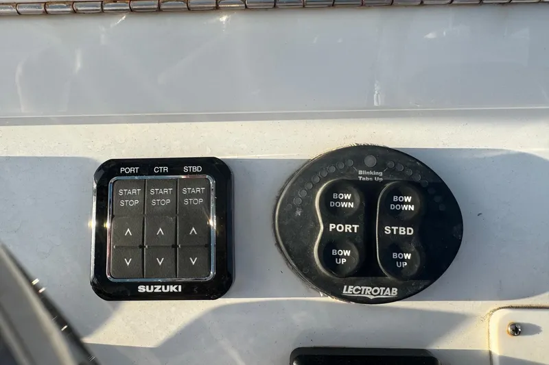 Slide: The Image of Control panel of a 2015 SeaHunter 41 Tournament boat with Suzuki and Lectrotab systems. - 23
