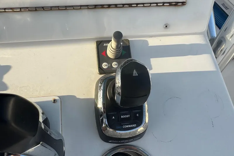 Slide: The Image of Control panel of a 2015 SeaHunter 41 Tournament boat with throttle and joystick. - 24