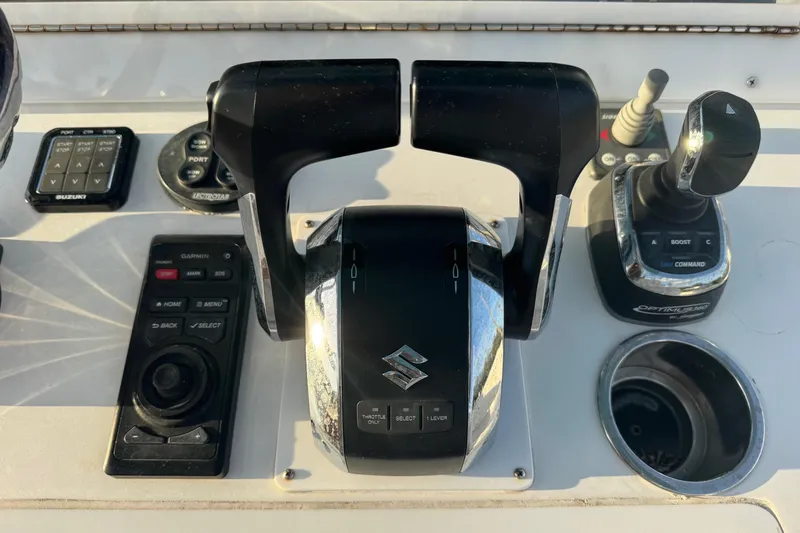 Slide: The Image of Control panel of a 2015 SeaHunter 41 Tournament boat with throttle and joystick. - 25