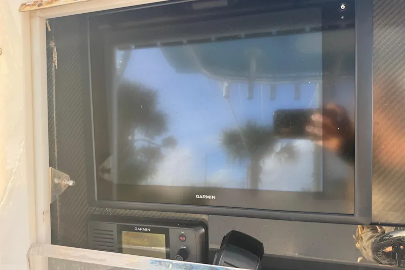 Slide: The Image of Garmin display on 2015 SeaHunter 41 Tournament boat, reflecting palm trees and sky. - 26