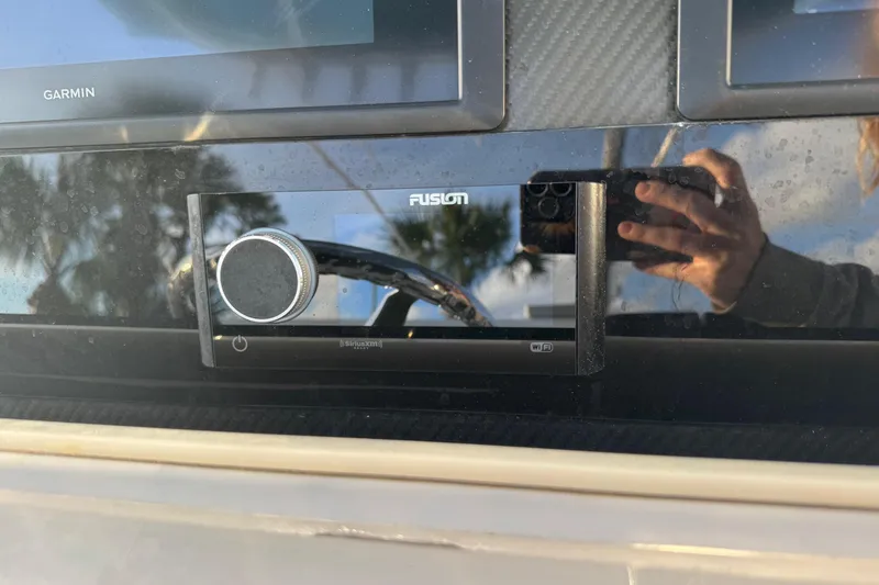 Slide: The Image of Fusion marine stereo on 2015 SeaHunter 41 Tournament boat dashboard with Garmin display. - 29