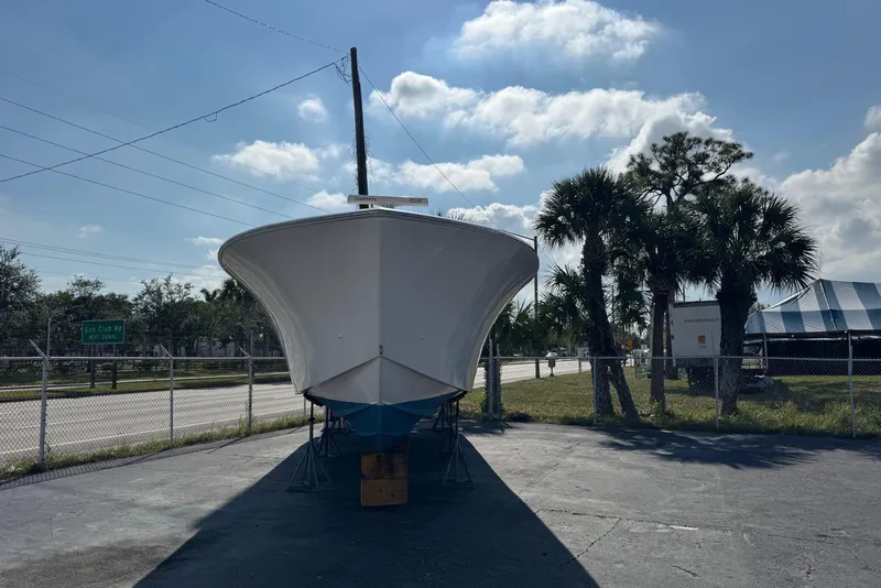 Slide: The Image of 2015 SeaHunter 41 Tournament boat on dry land, sunny day, palm trees nearby. - 3