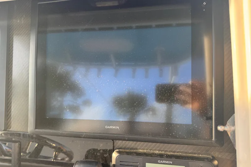 Slide: The Image of Garmin display on 2015 SeaHunter 41 Tournament boat dashboard, reflecting surroundings. - 30