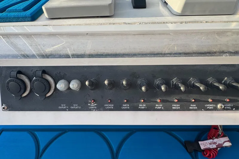 Slide: The Image of Control panel of a 2015 SeaHunter 41 Tournament boat with various switches and outlets. - 34