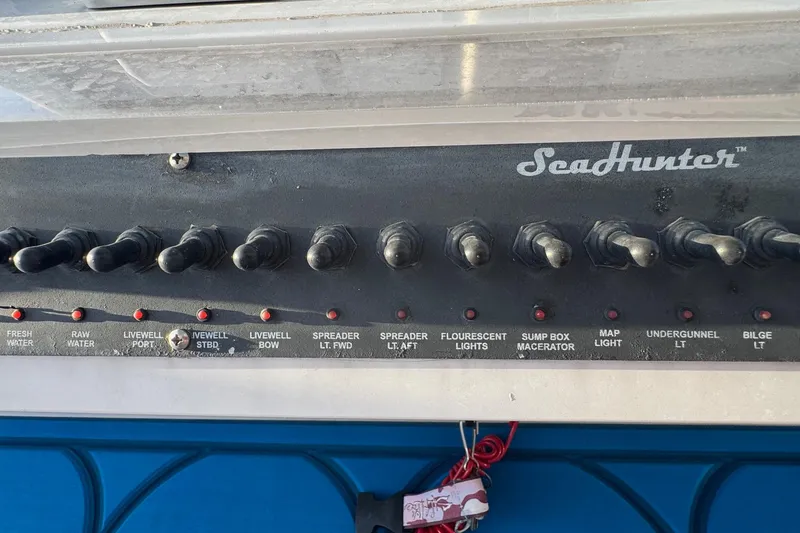Slide: The Image of Control panel of a 2015 SeaHunter 41 Tournament boat with labeled switches. - 35