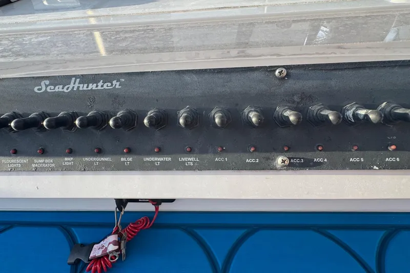 Slide: The Image of Control panel of a 2015 SeaHunter 41 Tournament boat with labeled switches. - 36