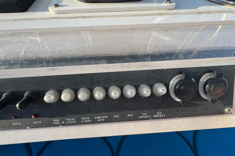 Slide: The Image of Control panel of a 2015 SeaHunter 41 Tournament boat with switches and outlets. - 37